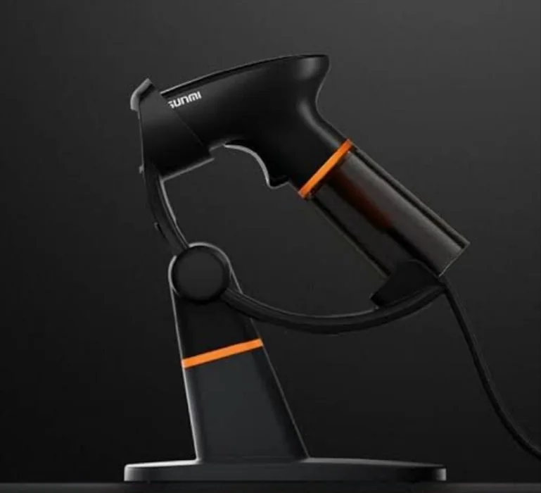 Handheld barcode scanner resting on a desktop stand